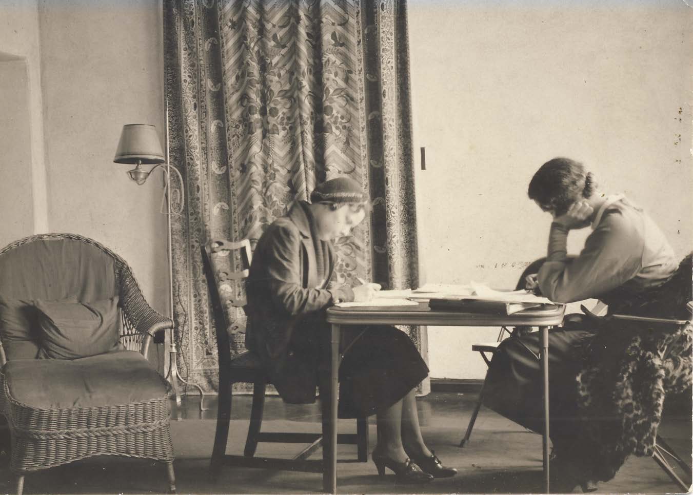 Two students of the Chicago Kindergarten College studying together at a desk, circa 1900.